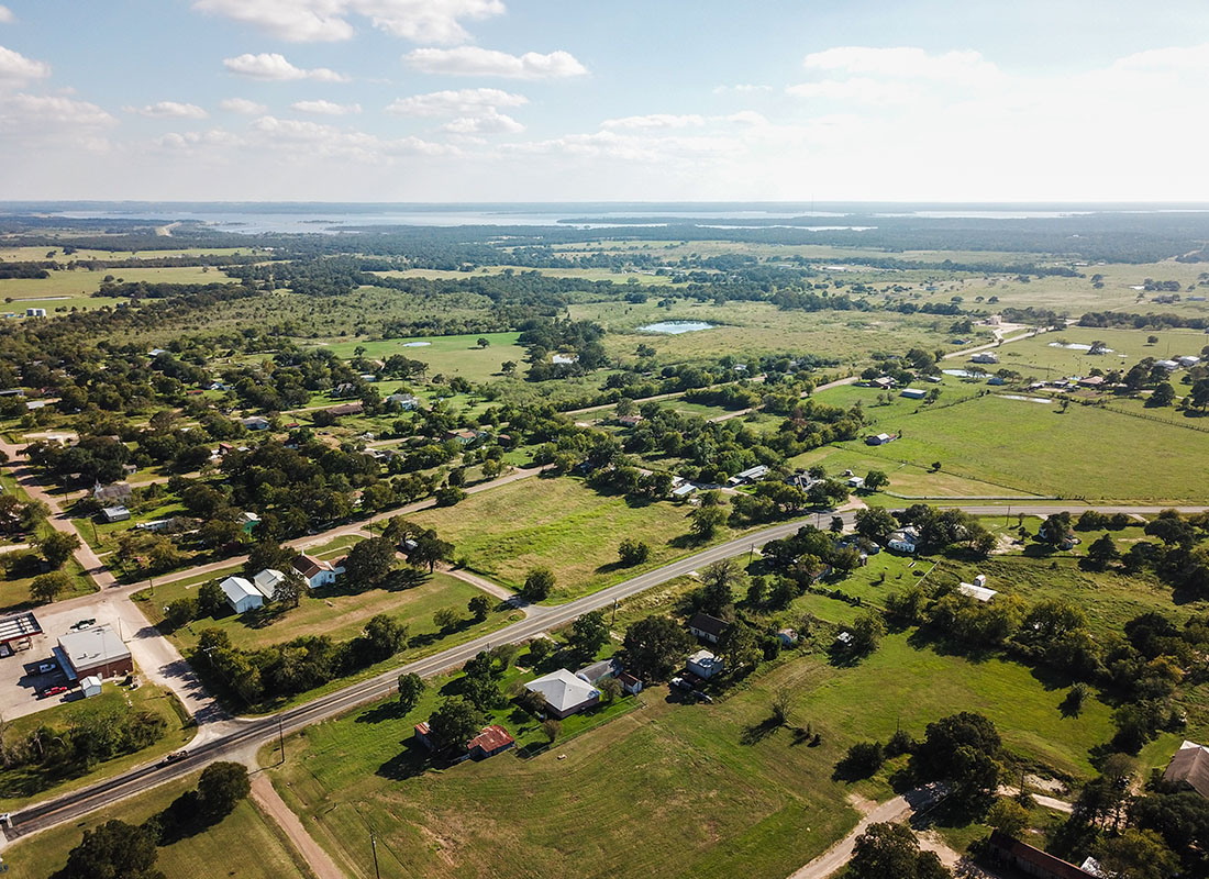 Contact - Aerial View of Homes and Green Fields in Rural Texas on a Sunny Day